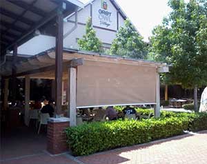 Transparent roller blind as wind barrier